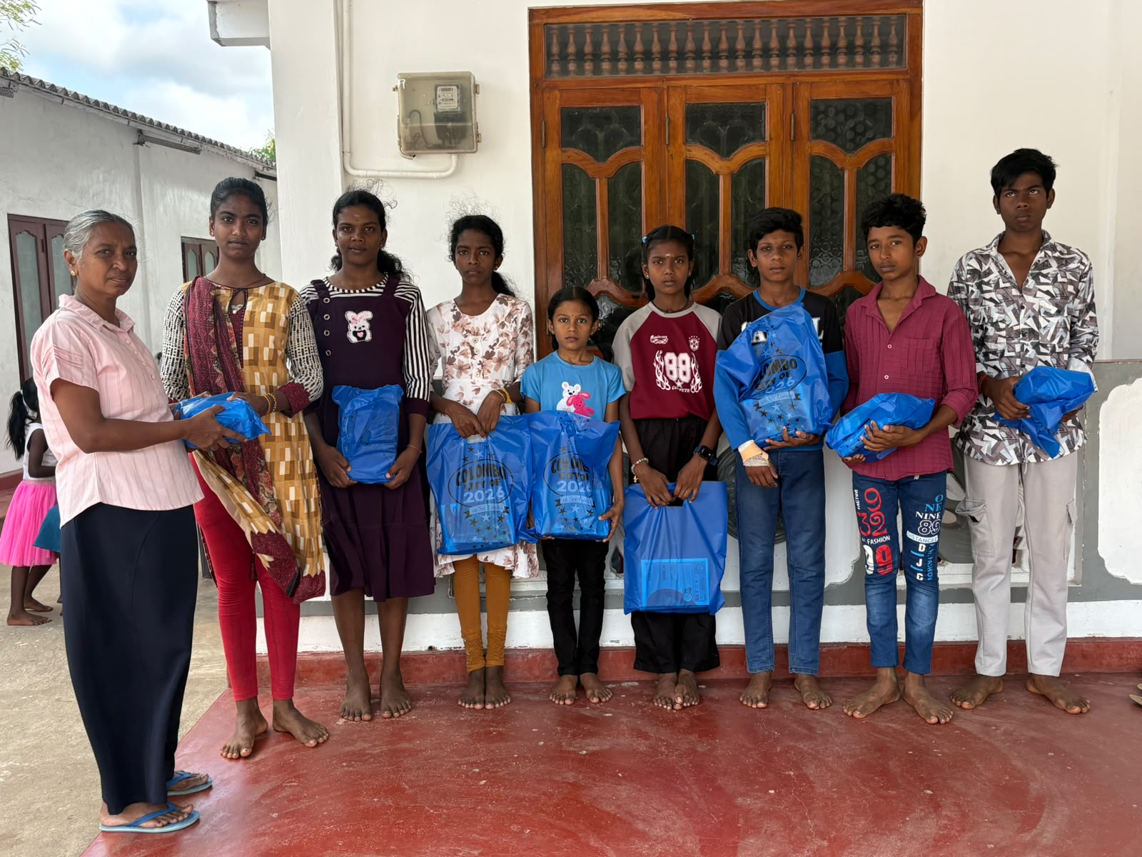 A volunteer hands out supply packs on a distribution day