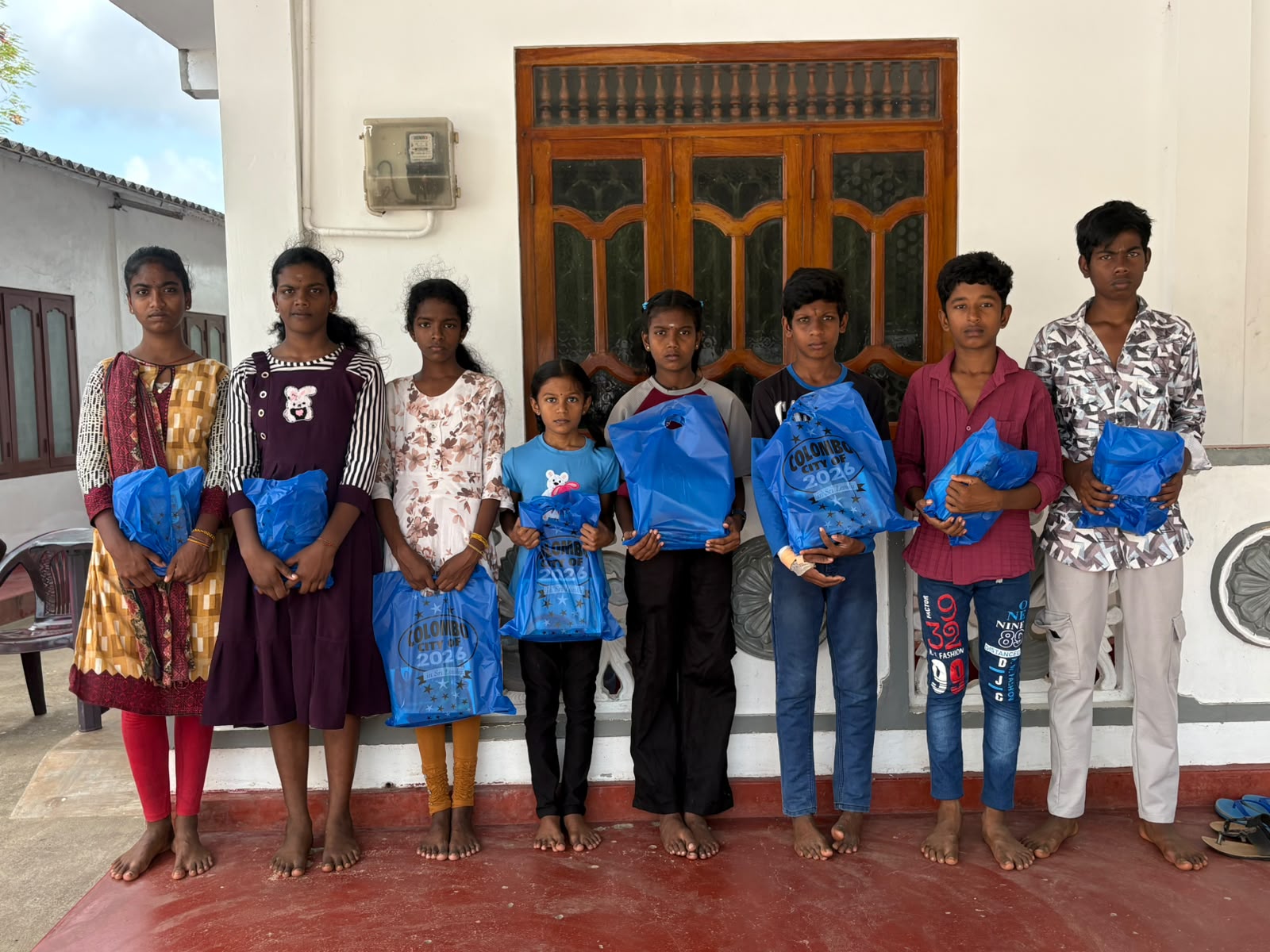 Children with their supply packs after a distribution